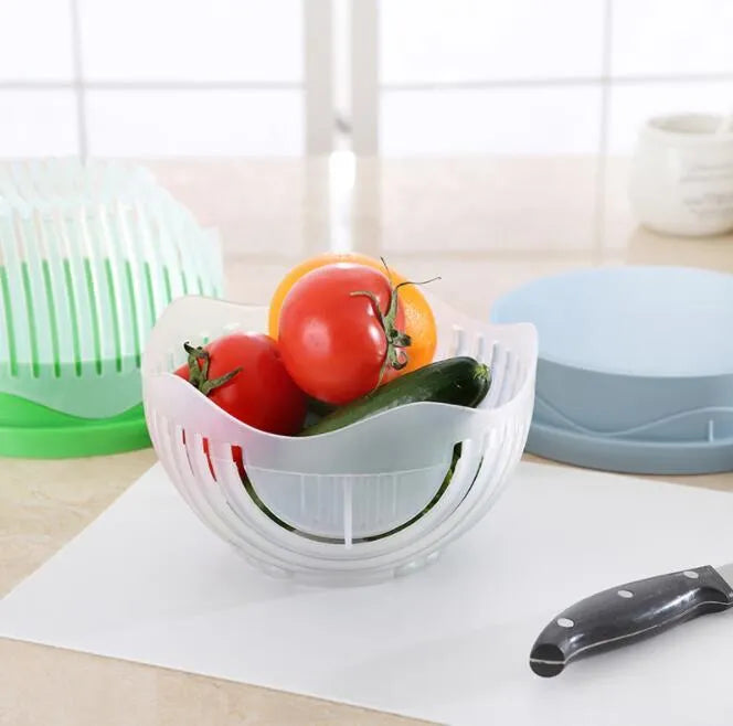 Blue salad cutter bowl showing removable cutting lid placed on a base with a raised rim.