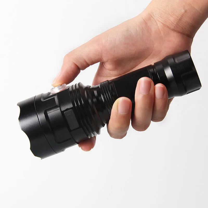 Black aluminium XHP90 LED tactical flashlight with push switch and charging port.