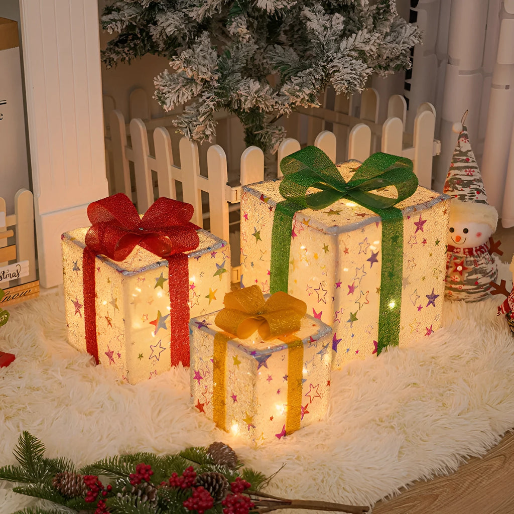 Set of three pre-lit Christmas gift box decorations with bows and LED lights for outdoor use