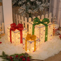 Set of three pre-lit Christmas gift box decorations with bows and LED lights for outdoor use