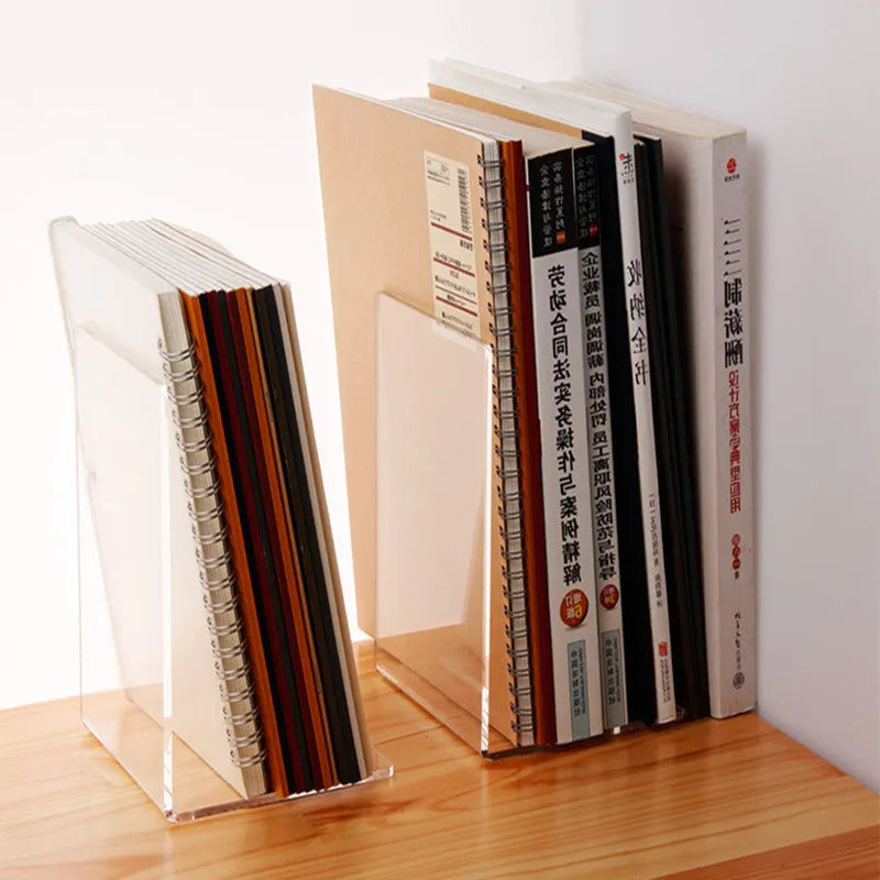 Transparent acrylic bookshelf displaying books in organised pairs on a desk