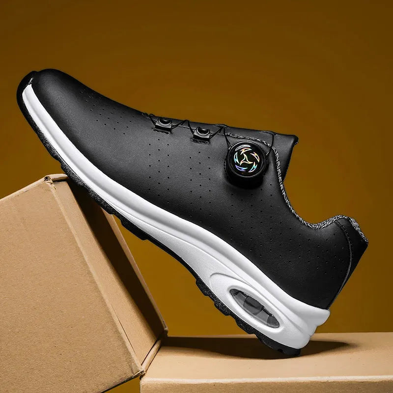 Man's black and white low-top casual tennis shoes with mesh upper and cross shoulder straps.