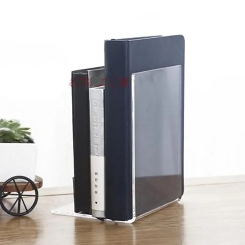 Transparent acrylic bookshelf displaying books in organised pairs on a desk