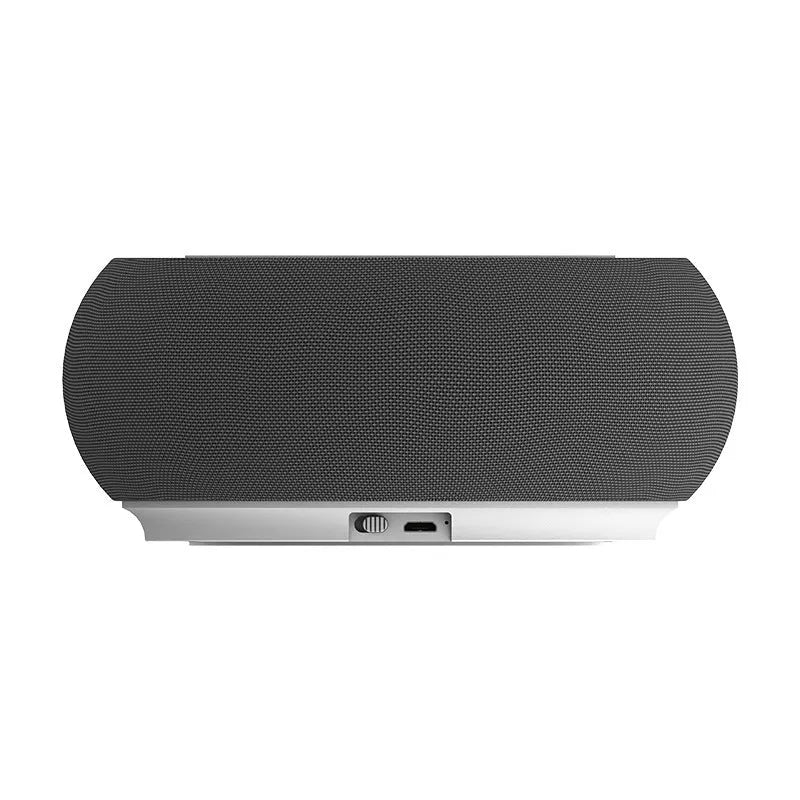 Black wireless Bluetooth speaker with dual speakers and subwoofer on a wooden table