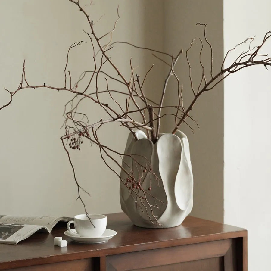 Irregular ceramic vase with resin flower device accents in magnesium clay material