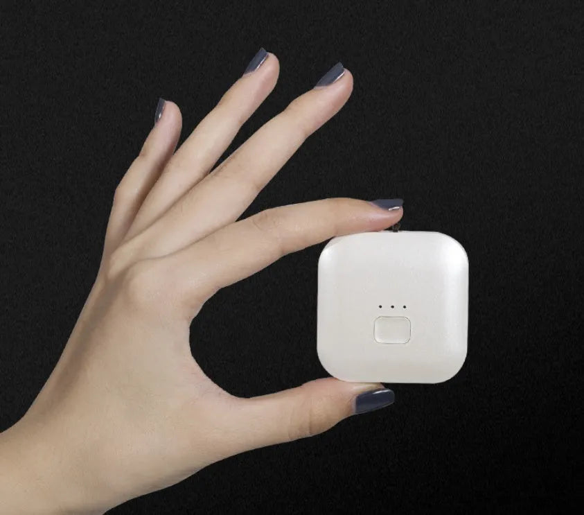 Compact USB-powered air purifier necklace in pink, showing wearable design and one-button control.