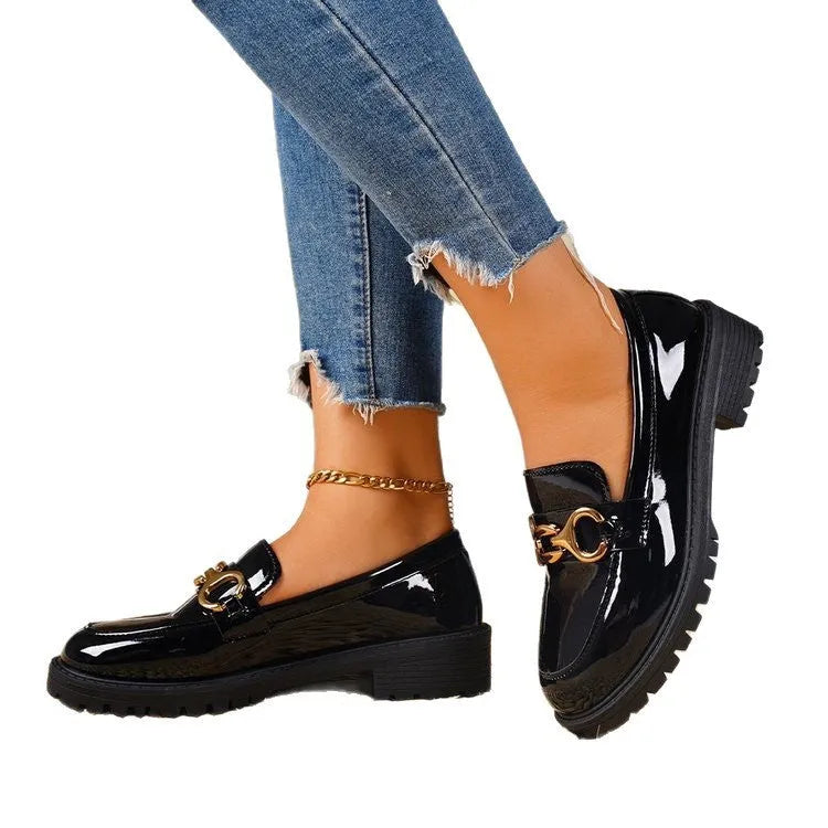 Women's black chunky heel round toe pumps with thick rubber sole and metal decoration