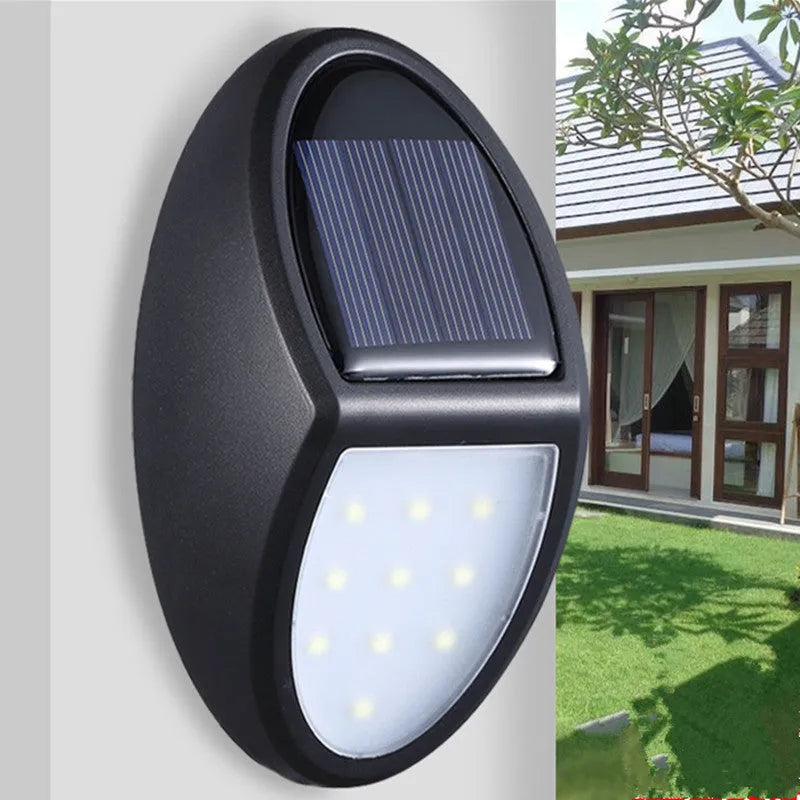 Black rectangular solar-powered LED wall light for outdoor garden use.
