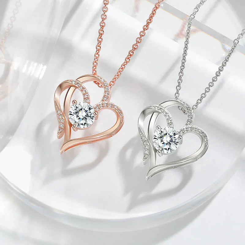 Women's heart-shaped 925 silver necklace with diamond-cut treatment on a model.