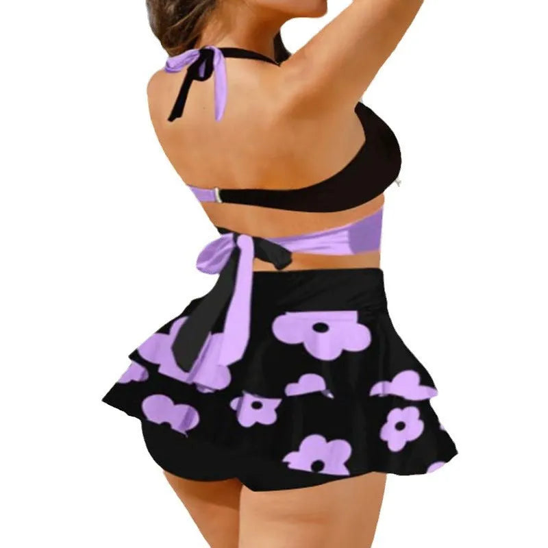 Purple women's high-waisted bikini swimsuit with lace-up detail and matching skirt for swimming