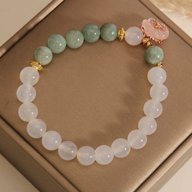 Women's floral bracelet made of white agate and jadeite stones set in jade.