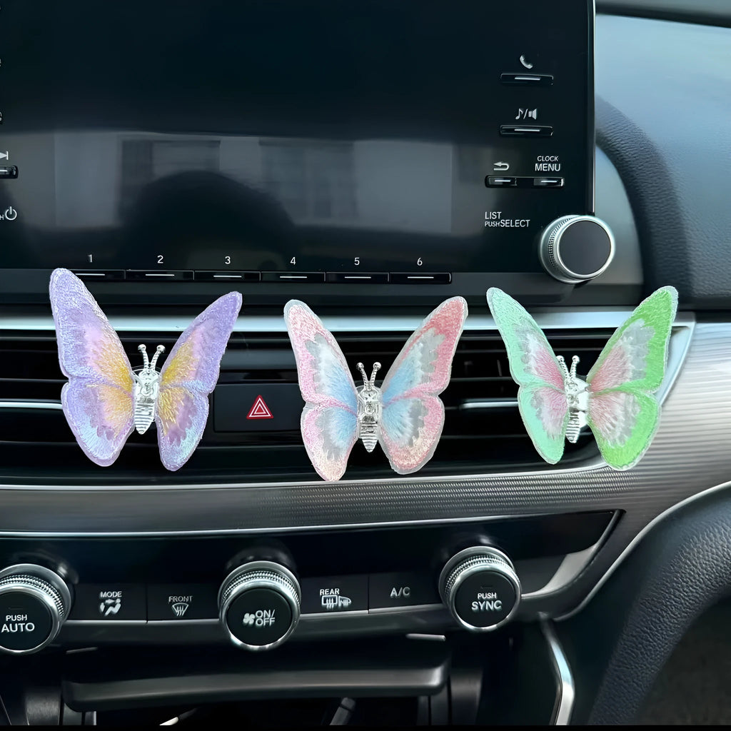 Fabric butterfly car air vent decoration in multiple colours, showing clip and paste fitting options.