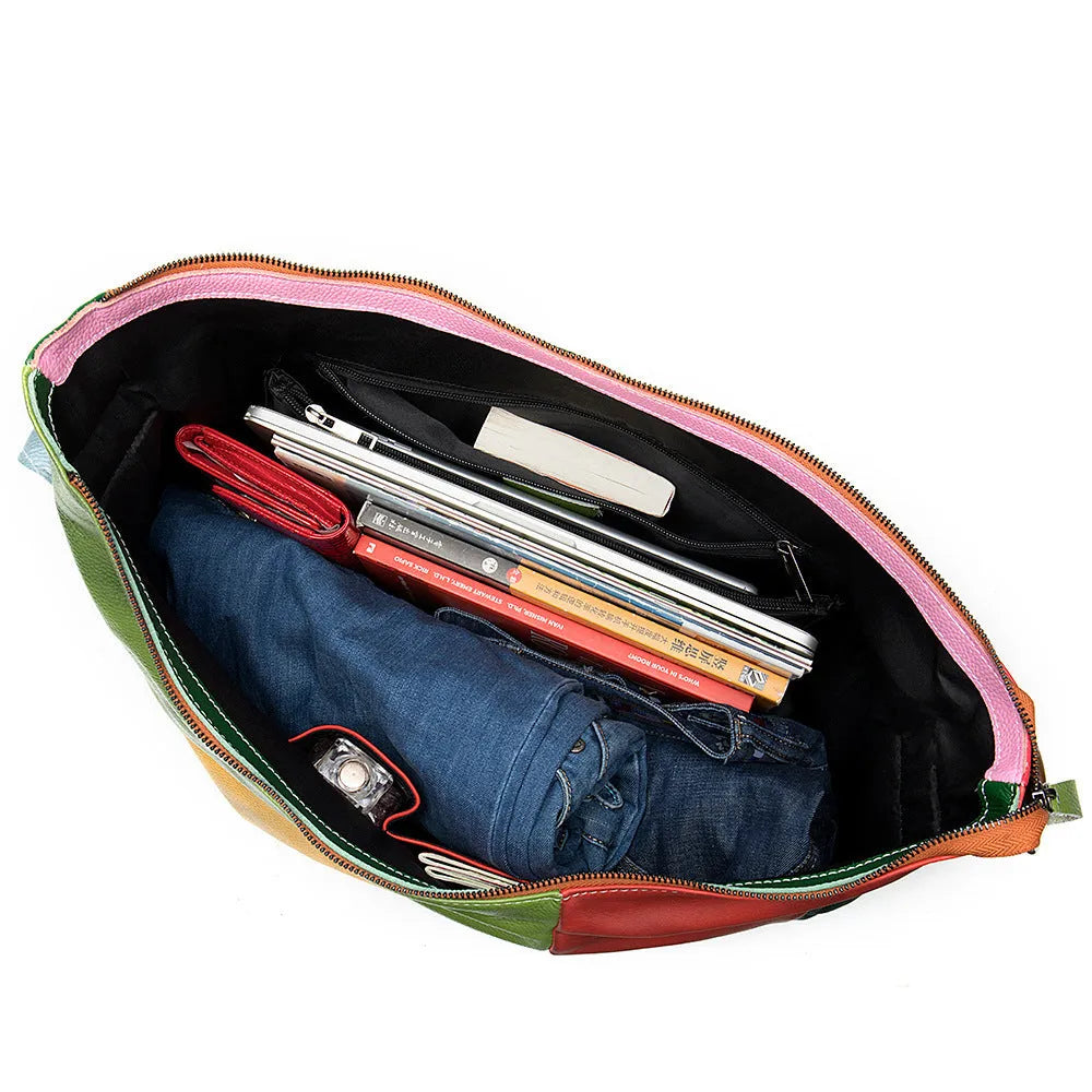 Brown cowhide leather crossbody travel bag open to show a 15-inch laptop and iPad inside.