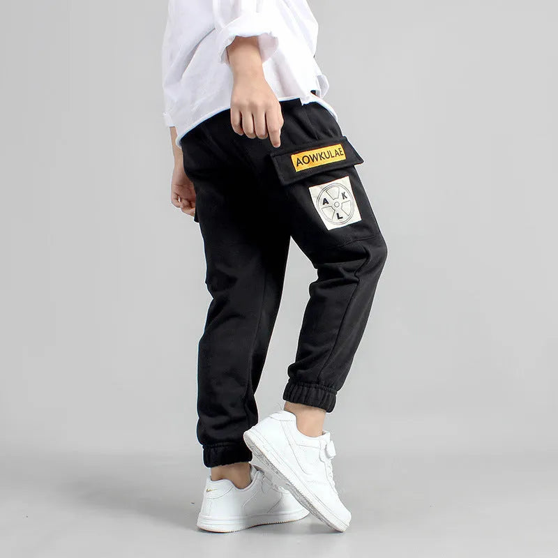 Boys' cotton track pants in black and grey, sizes 120-160cm, with elasticated hips
