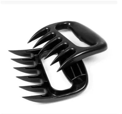Two black bear claw meat shredders for barbecue preparation on kitchen counter