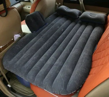 Black thickened flocking inflatable car bed set up in a vehicle with pillows.