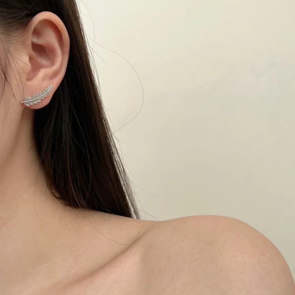 Leaf-shaped zircon inlaid S925 sterling silver stud earrings in gold colour on white background