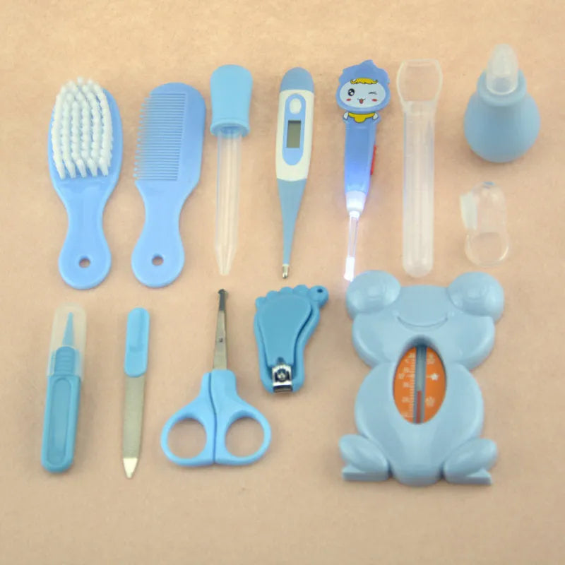 Roadfisher Newborn Baby Care Kit in pink or blue, showing safety scissors, brush, comb, thermometer, and syringe.