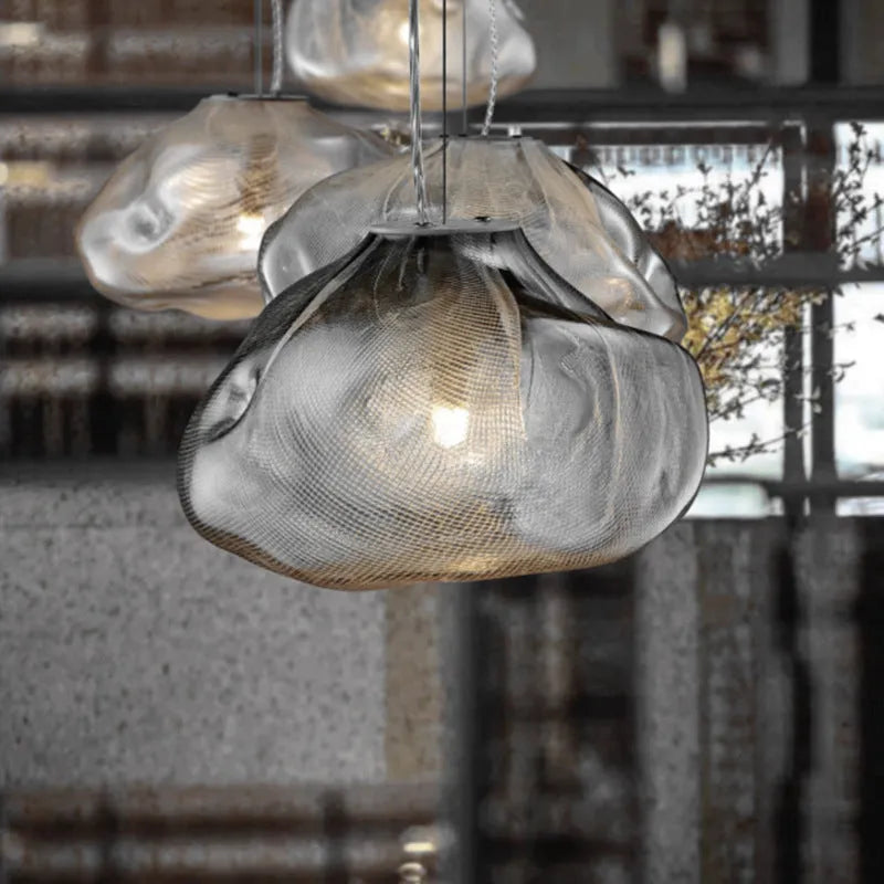 Modern light luxury glass chandelier in amber, clear, and smoke grey colours for lounge lighting.