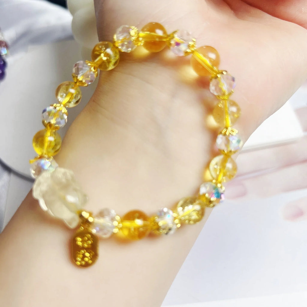 Handmade natural citrine crystal bracelet with detailed nine-tail fox design on a white background.