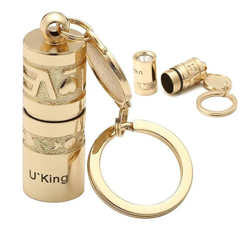Gold-colour zinc alloy waterproof mini LED flashlight on a keychain ring.