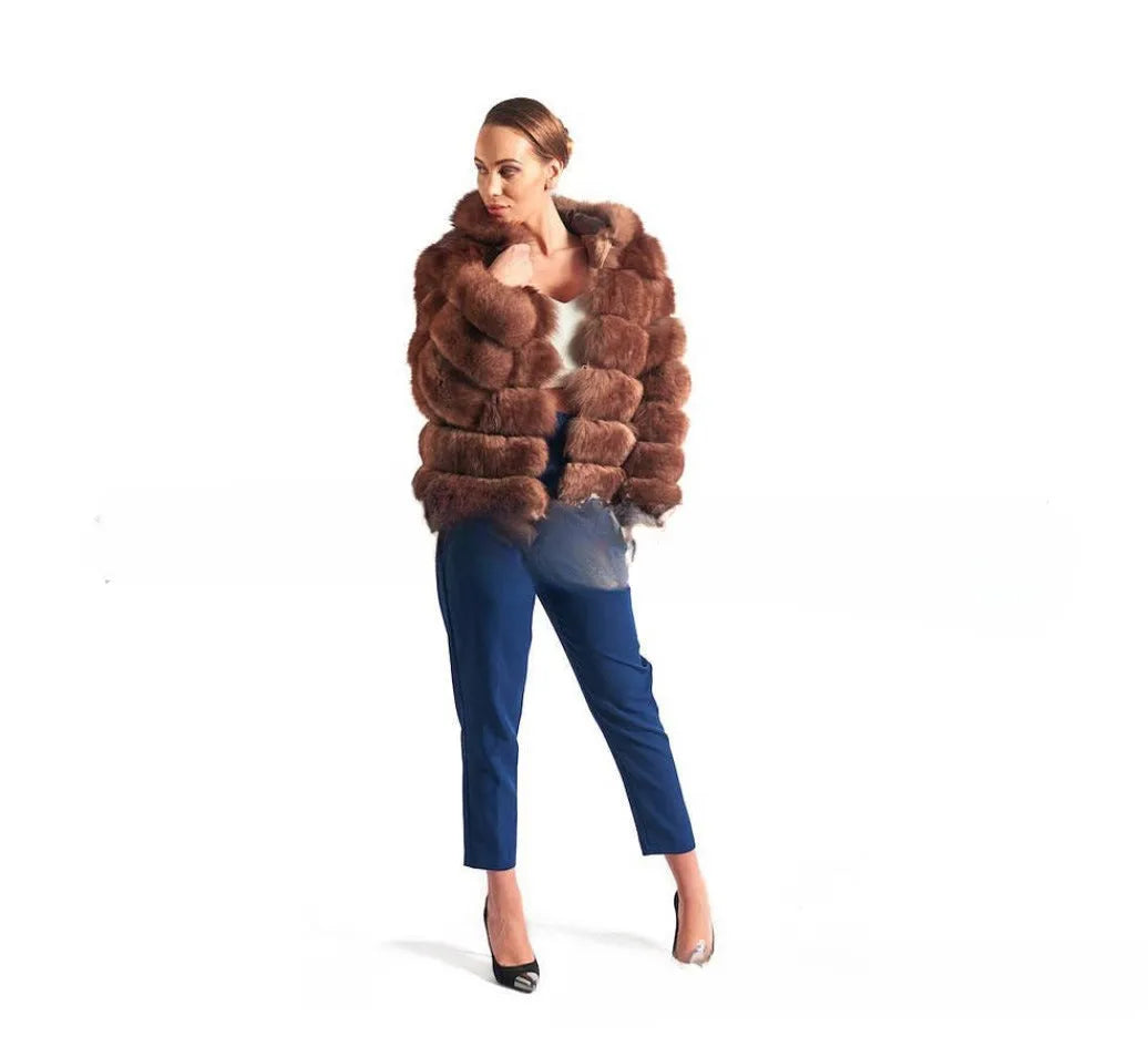 A woman wearing a loose-fitting artificial fur coat with a hood, in a street fashion style.