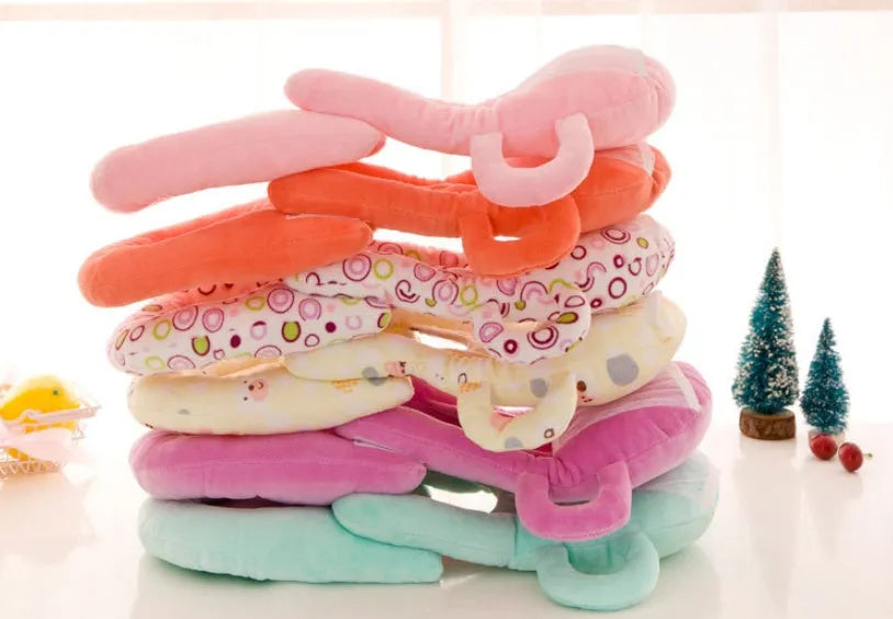 Plush confinement baby feeding pillow in soft colours, measuring 30cm by 42cm.
