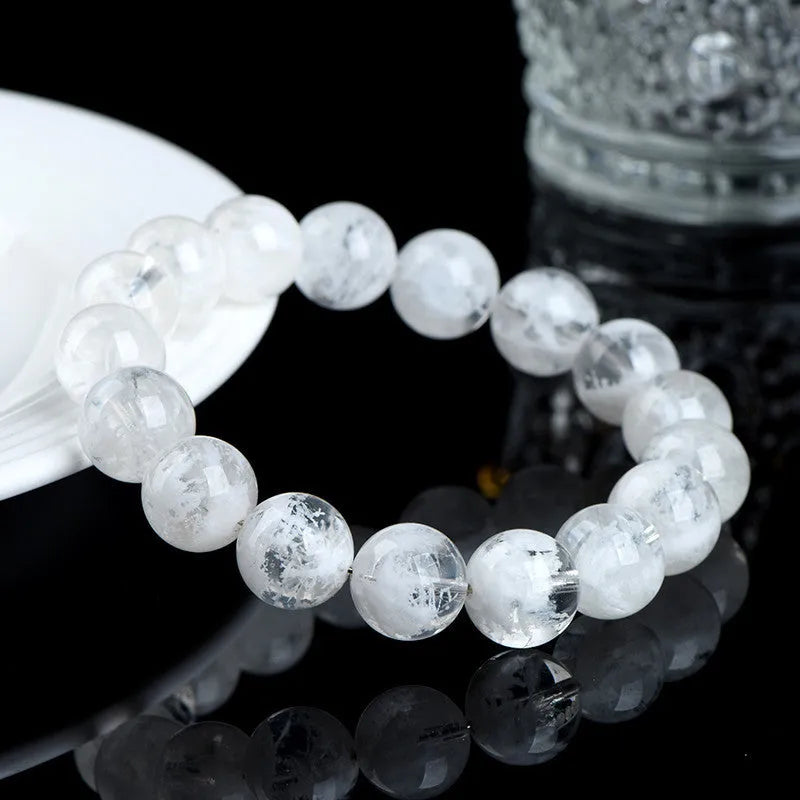 Women's crystal bracelet with round blizzard snowflake beads and traditional Ruyi and Xiangyun symbols.