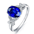 Close-up of a women's rose gold plated butterfly ring shaped like a heart with coloured enamel details.