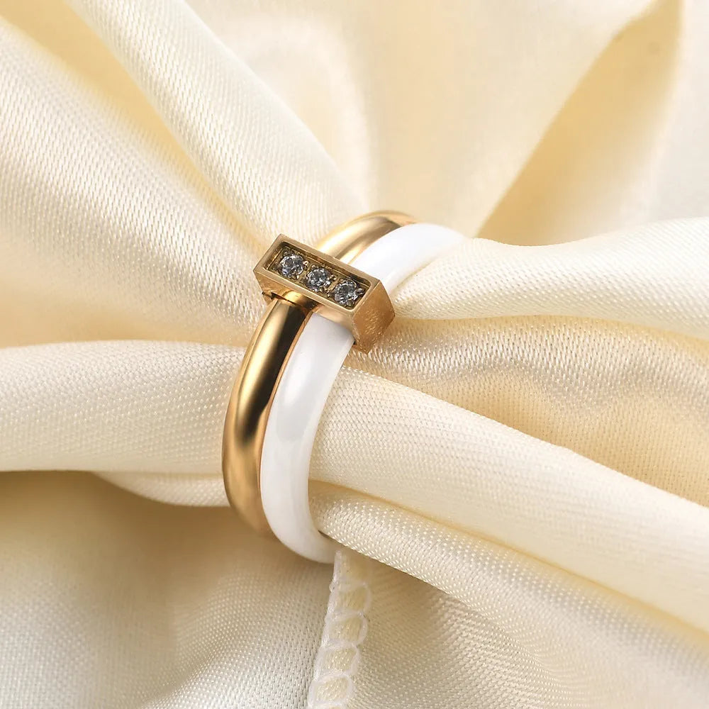 Close-up of a women's black ceramic ring with a geometric stitch pattern on a 6mm wide band, showcasing glossy finish.