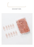Rose gold coloured heart-shaped metal paper clips, pack of 100 pieces.