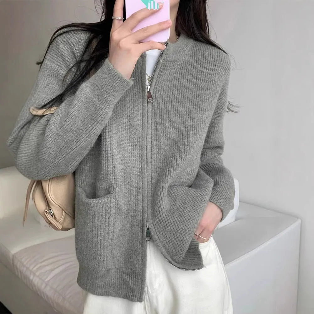 Beige viscose knit sweater coat cardigan with long sleeves laid flat.