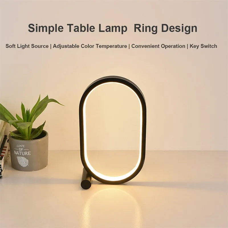 USB plug-in oval acrylic touch dimmable night light with metal base on a desk, black colour