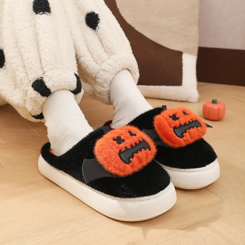 Black Halloween cartoon pumpkin slippers with small wings design on indoor floor