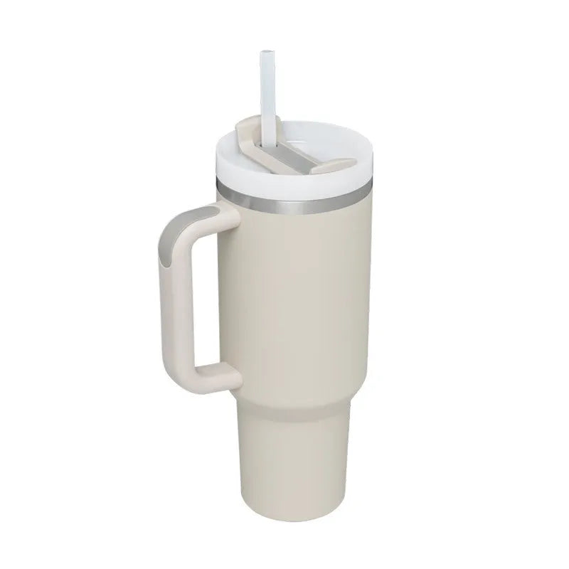40 oz stainless steel insulated tumbler with a black handle, straw, and grey lid on a wooden table