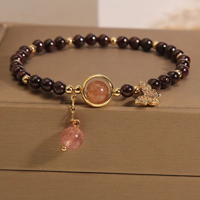 Black butterfly pendant bracelet with stone construction and red rock elements