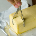 Stainless steel butter cutter with 12cm blade and sharp edge on a surface