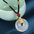 Silver necklace with peace buckle agate pendant showing safety clasp detail