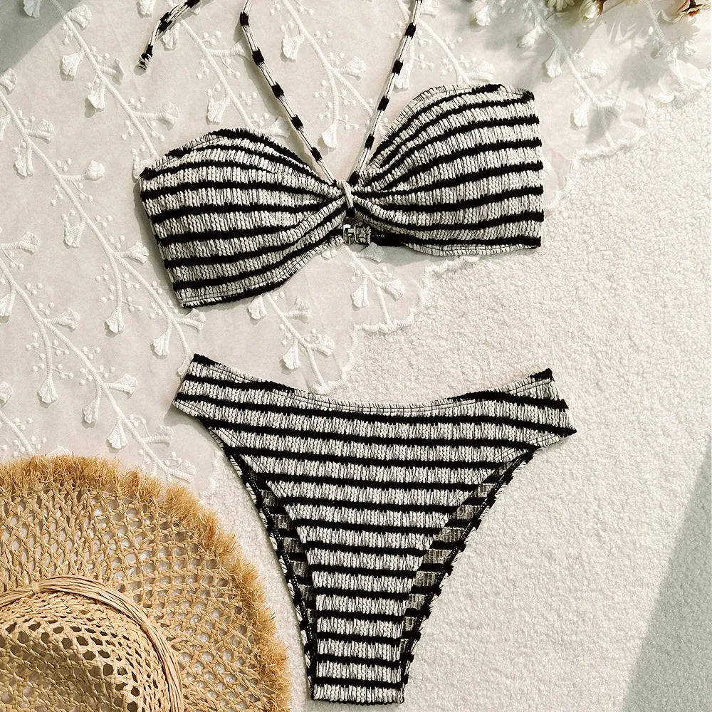 Women's pink and black striped bikini swimsuit top and briefs on a mannequin