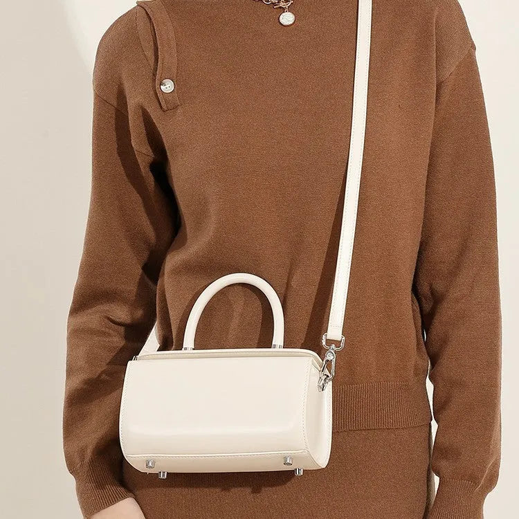 Women's cowhide leather crossbody bag in clamshell design with single shoulder strap