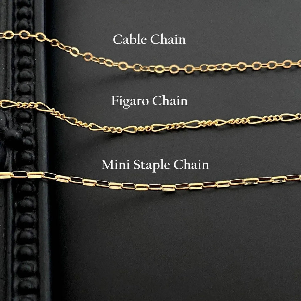 Stainless steel ghost pendant necklace on a twisted chain, showing titanium steel charm.