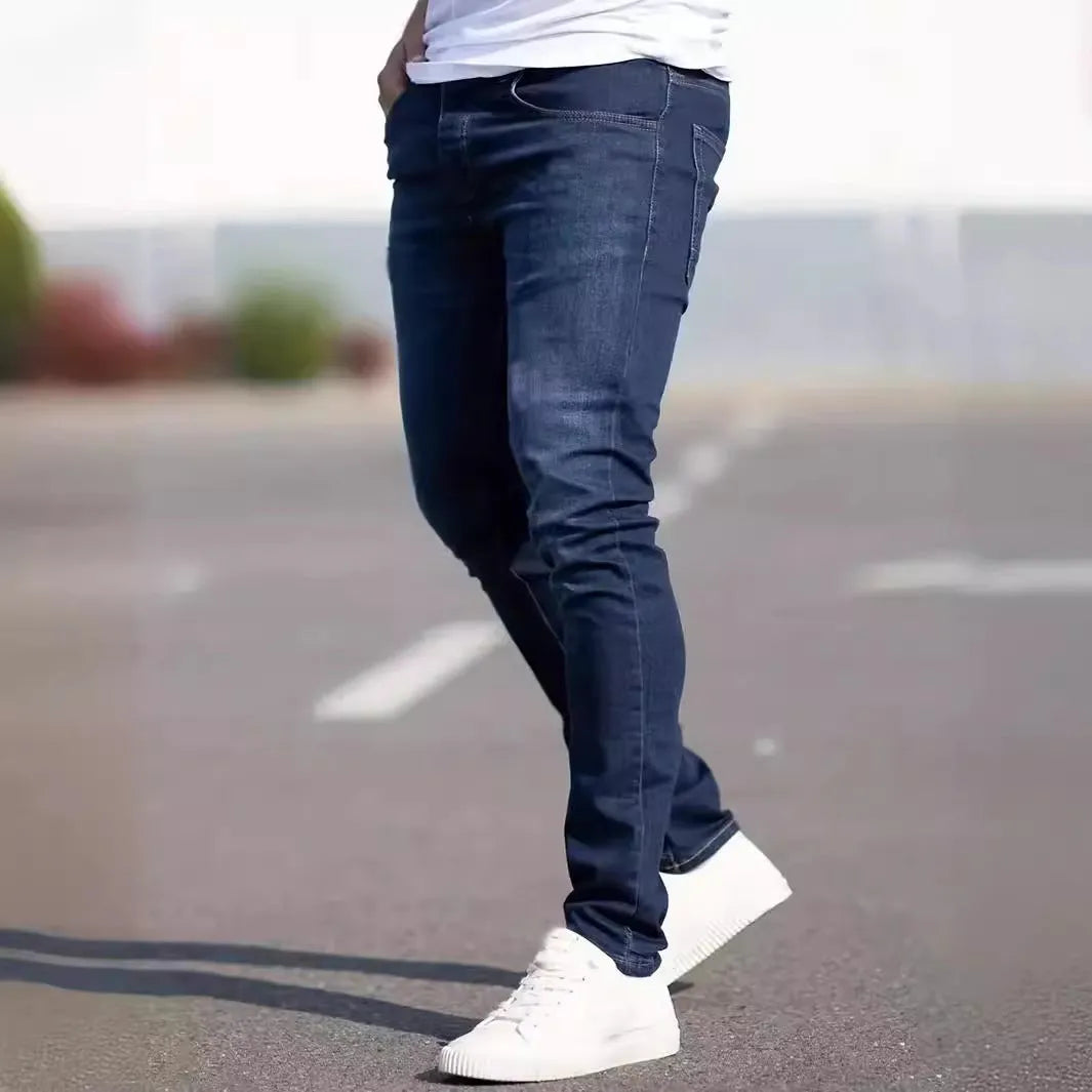 Man wearing dark blue slim-fit skinny jeans with a medium-elastic waist and zipper fly.