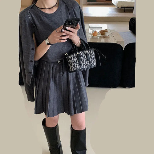Women's grey knitted vest skirt and long-sleeve cardigan set with 3D pattern and an adjustable waist belt.