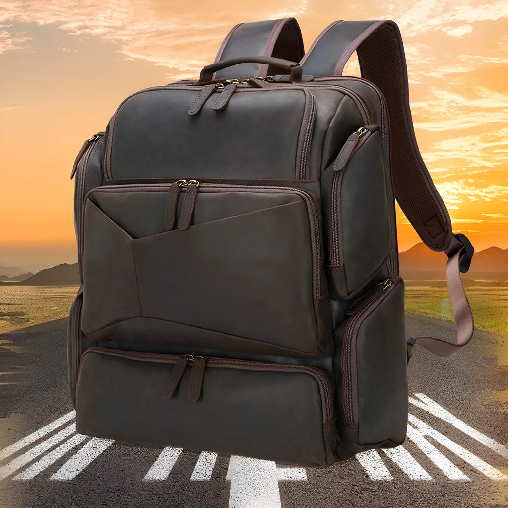 Dark brown genuine leather backpack for a 17-inch laptop, showing multiple pockets and double shoulder straps.