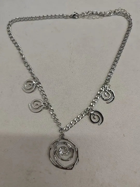 Spiral donut design jewellery set with necklace, bracelet and ear hooks in gold or silver finish