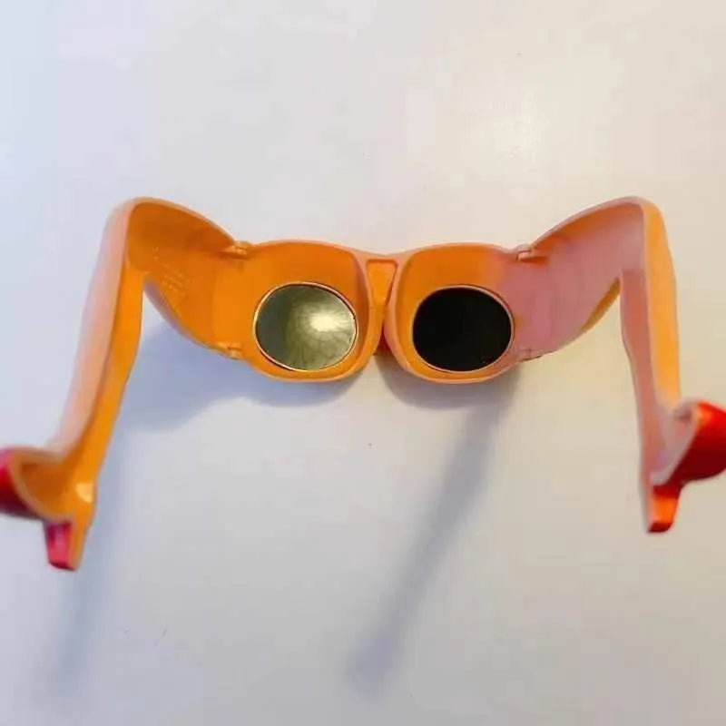 Orange novelty sunglasses with a sculptural leg and hip design on a white background.