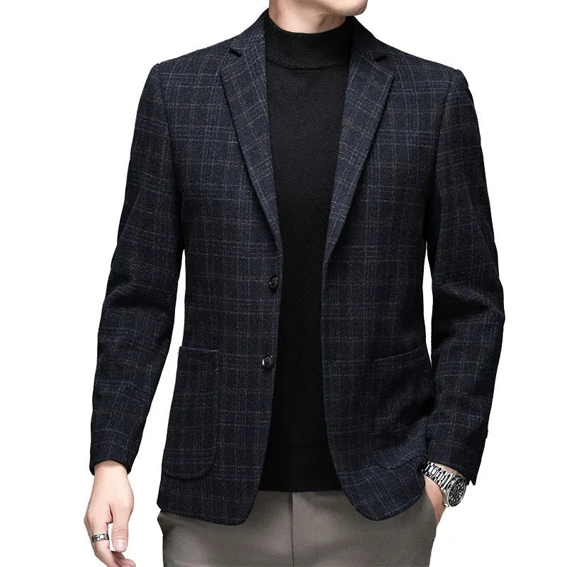 Man wearing a thick grey casual wool-style suit jacket with a loose fit and round hem.