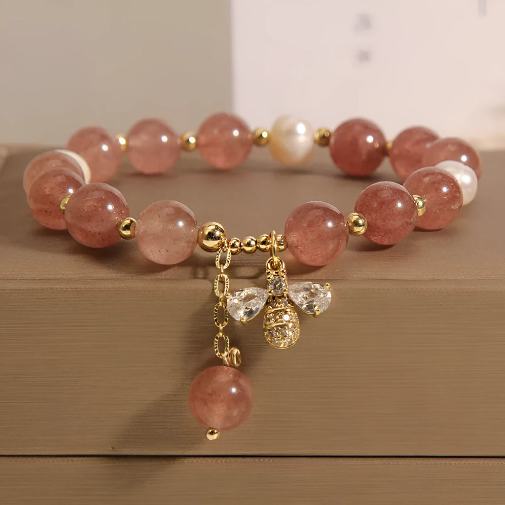 Women's bracelet with strawberry quartz beads, three freshwater pearls, and sparkling zircon details on a metal chain.