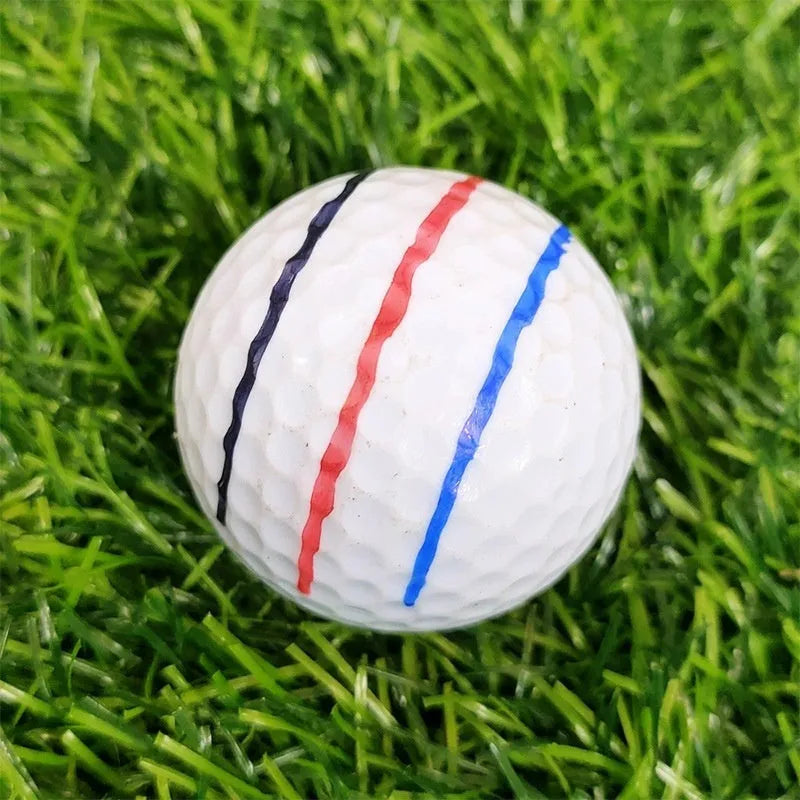 Plastic golf ball alignment scriber tool with drawing pen on a green putting surface