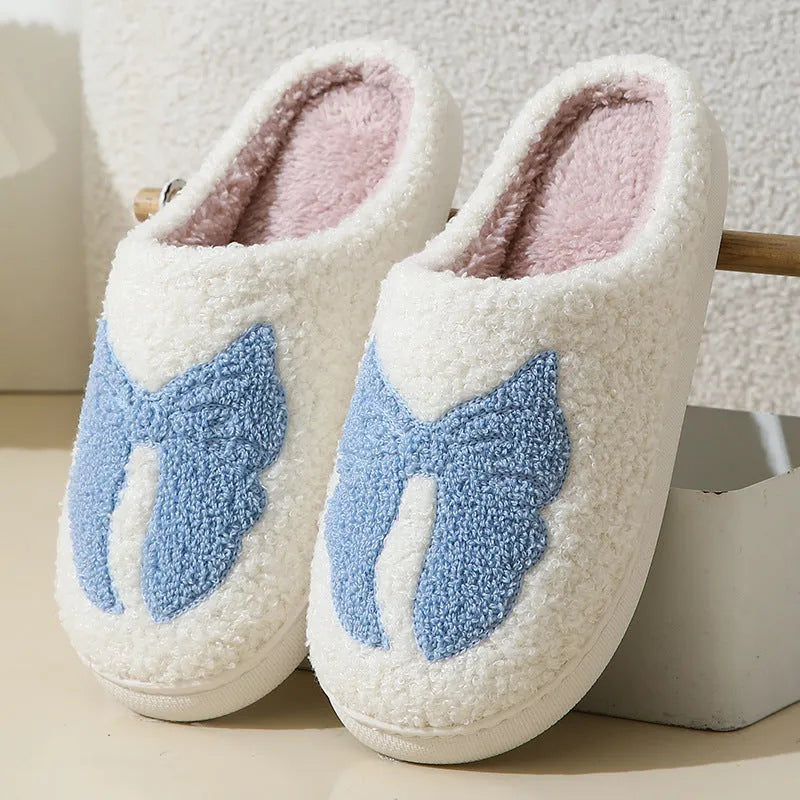 Pink and blue cartoon bow knot oversleeve slippers with suede upper and TPR sole.